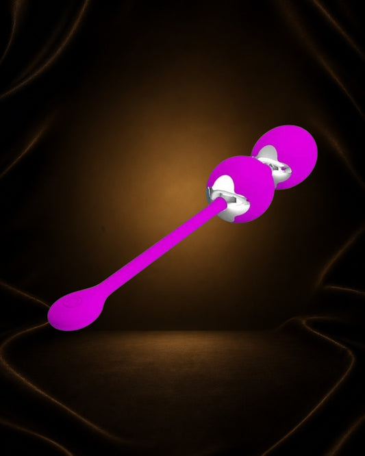 Bolas Kegel con vibración Éxtasis Boutique en color fucsia, de silicona y metal, con diseño ergonómico para el suelo pélvico.
